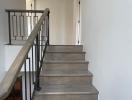 Modern staircase with wooden steps and metal handrails in a residence