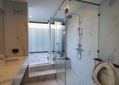 Modern bathroom with marble finishes and glass shower enclosure