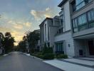 Modern residential building exteriors with a street view at dusk