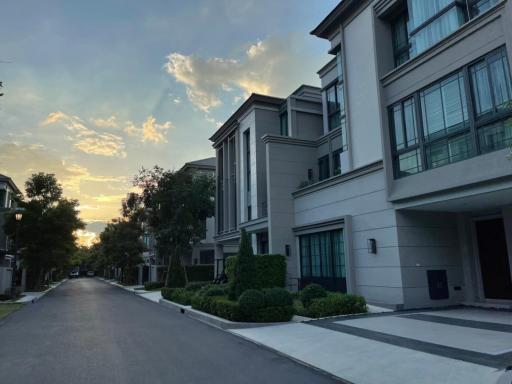 Modern residential building exteriors with a street view at dusk