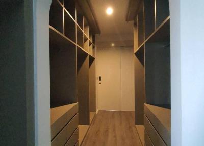 Modern corridor with wooden flooring and built-in storage