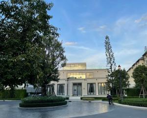 Modern single-family home with spacious front yard and clear blue sky