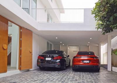 Modern home exterior with parking area featuring two cars