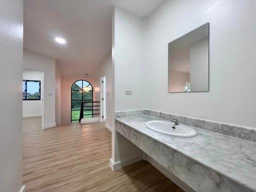 Spacious modern bathroom with large mirror and abundant natural light