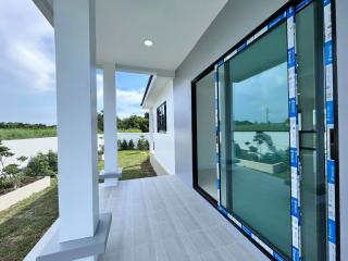 Covered patio area with sliding glass doors and a view of the surrounding landscape