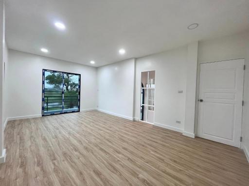 Spacious and well-lit empty living room with large windows and modern flooring