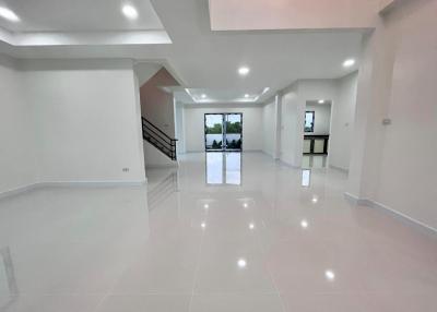 Spacious modern living area with glossy tiled flooring and multiple lighting options