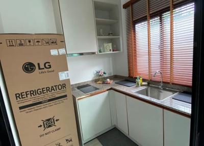 Modern kitchen with new appliances and wooden blinds