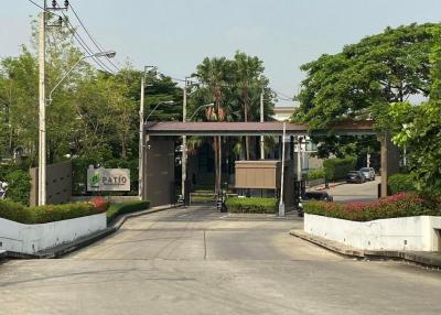 Gated Community Entrance with Lush Greenery