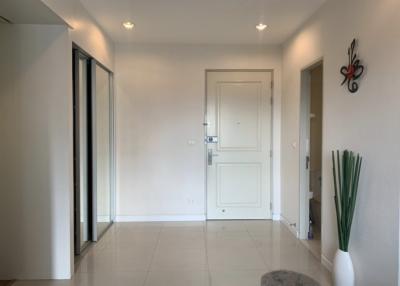 Bright and modern entryway with white walls and tiled flooring