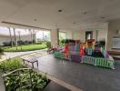 Spacious outdoor common area with children's playground and seating arrangements