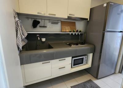 Modern compact kitchen with stainless steel appliances