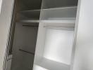 Built-in bedroom closet with open doors showcasing shelves and drawers