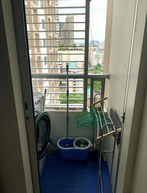 Compact balcony with laundry area and city view