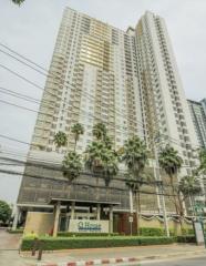 Tall modern residential building with palm trees in the foreground