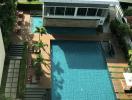 Aerial view of a building complex with a large swimming pool