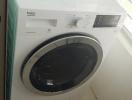 Modern Beko washing machine in a bright laundry area