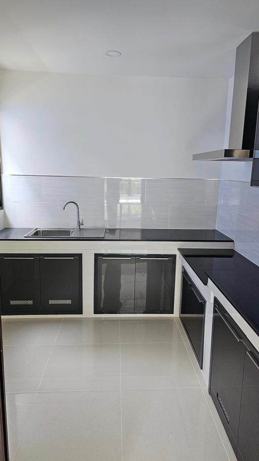 Modern kitchen with stainless steel appliances and white tiles