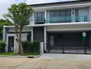 Modern two-story house with balcony and garage front view