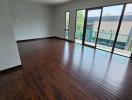 Spacious and well-lit empty living room with large windows