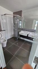 Modern bathroom with walk-in shower and dual sink vanity