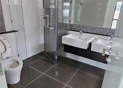 Modern bathroom with walk-in shower and dual sink vanity