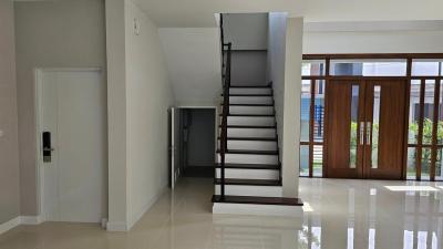 Spacious interior with staircase and gleaming tiled floor