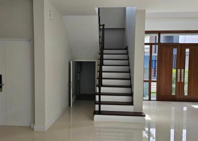 Spacious interior with staircase and gleaming tiled floor