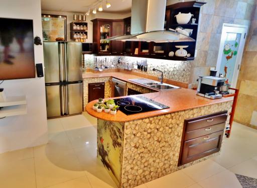 Spacious kitchen with modern appliances and stone countertop island
