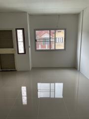 Empty interior space of a building with tiled floors and visible window