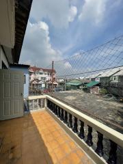 Spacious balcony with safety net overlooking the neighborhood