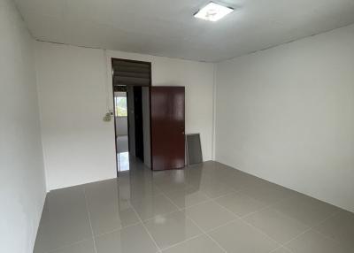 Empty spacious room with white walls and tiled floor