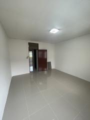 Empty spacious room with white walls and tiled floor