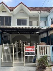 Two-story residential house with front gate and a 