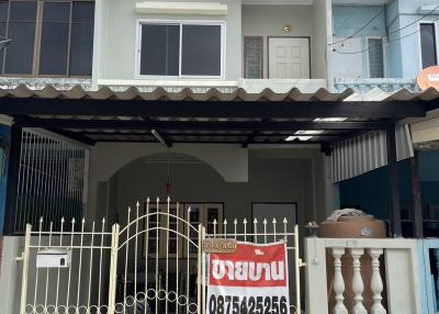 Two-story residential house with front gate and a 