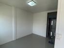 Empty room with grey floor and white walls