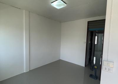 Empty room with grey floor and white walls