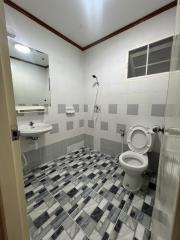 Compact tiled bathroom with white fixtures