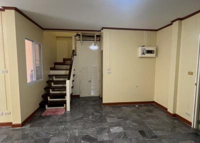 Spacious living area with stairway and air conditioning unit