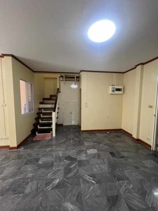 Spacious living area with stairway and air conditioning unit