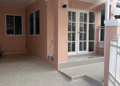 Spacious patio area with tile flooring and large windows