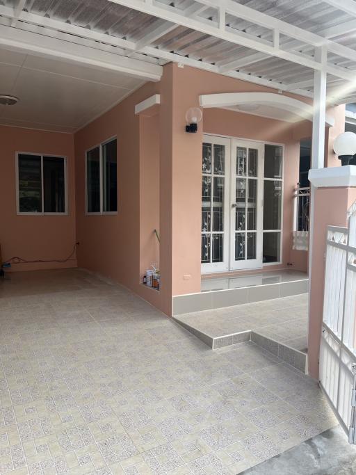 Spacious patio area with tile flooring and large windows