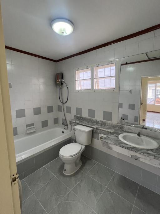 Modern bathroom with bathtub and neutral color tiles