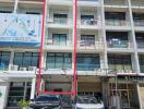 Modern multi-story commercial building facade with clear sky