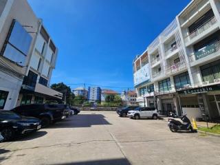 Exterior view of modern buildings with parking lot under blue sky