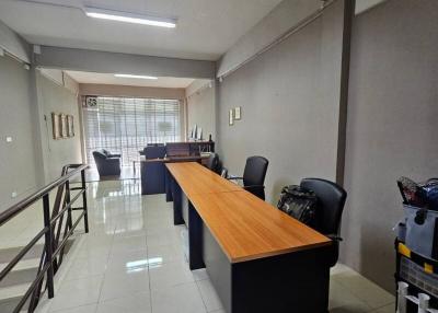 Modern office space with large desks and natural lighting