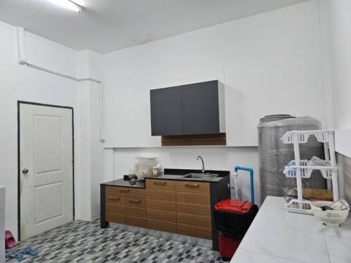 Compact kitchen with white walls and checkered floor