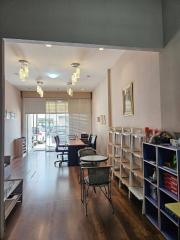 Home office interior with a desk, chair, bookshelves, and decorative lighting