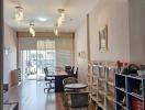 Home office interior with a desk, chair, bookshelves, and decorative lighting