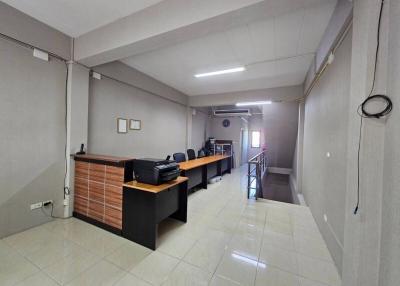 Spacious and modern open-space office interior with desks and chairs, ideal for businesses